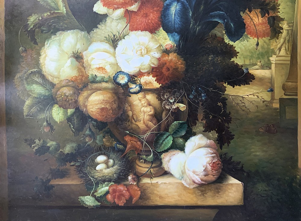A monumental oil painting depicting a detailed floral arrangement in a stone classical urn set within an architectural stone arch. View V