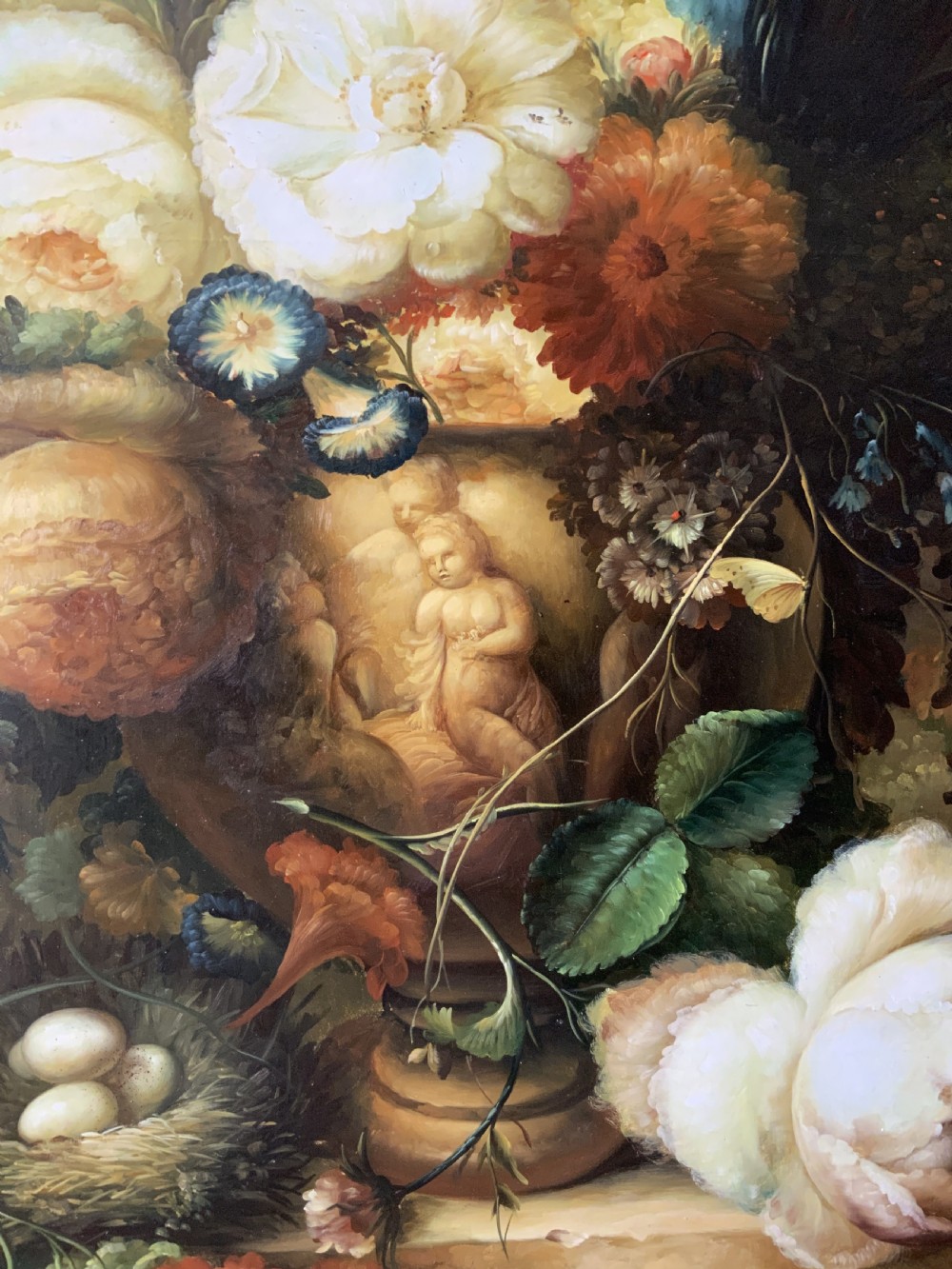 A monumental oil painting depicting a detailed floral arrangement in a stone classical urn set within an architectural stone arch. View VI