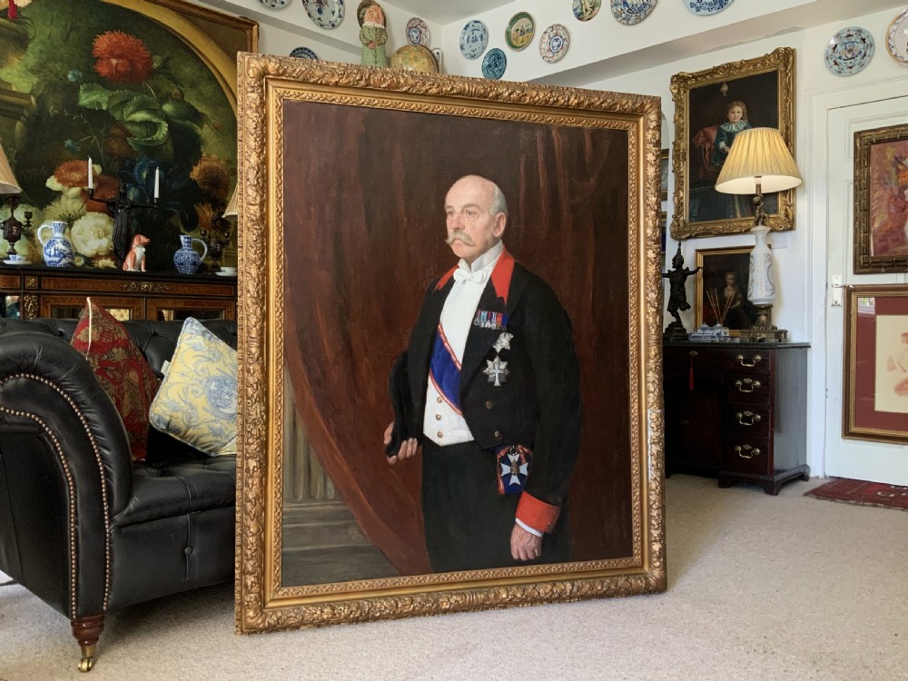 An antique oil painting depicting a military officer in formal dress uniform with medals, housed inside an ornate gilded wooden frame. View II