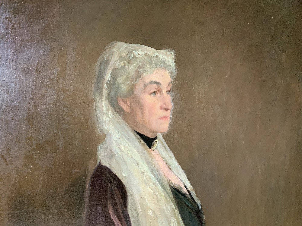 A large framed oil portrait painting on canvas depicting a mature woman wearing a lace head covering and draped red shawl against a dark brown background. View IV