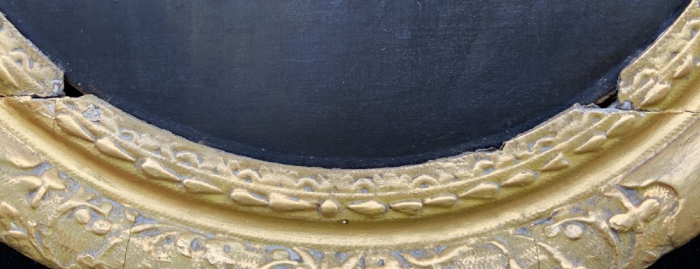 A seventeenth-century oval oil portrait of a gentleman with grey hair wearing a black coat and white collar, housed in a carved gold leaf frame. View VI