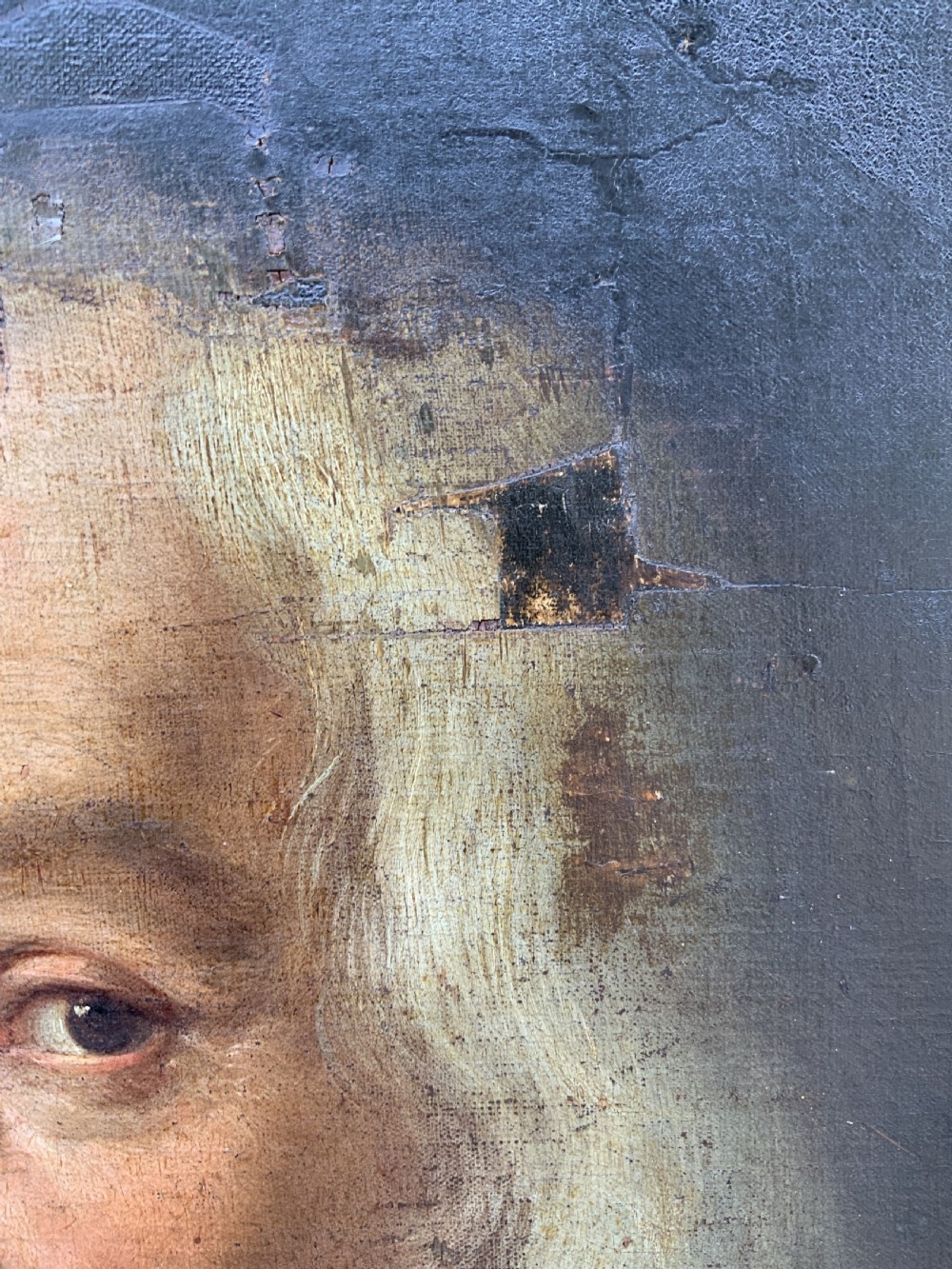 A seventeenth-century oval oil portrait of a gentleman with grey hair wearing a black coat and white collar, housed in a carved gold leaf frame. View VIII