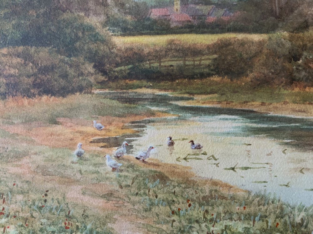 A framed watercolour painting depicting a tranquil river landscape in Buckinghamshire with trees and birds, set inside a gold mount and beaded gilt frame. View X