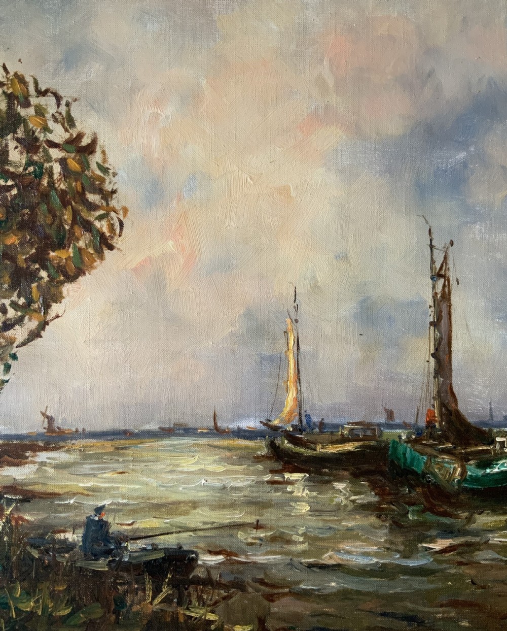 An impressionistic Dutch canalscape oil painting depicting traditional barges alongside a grassy riverbank, housed in an ornate carved gold frame. View V