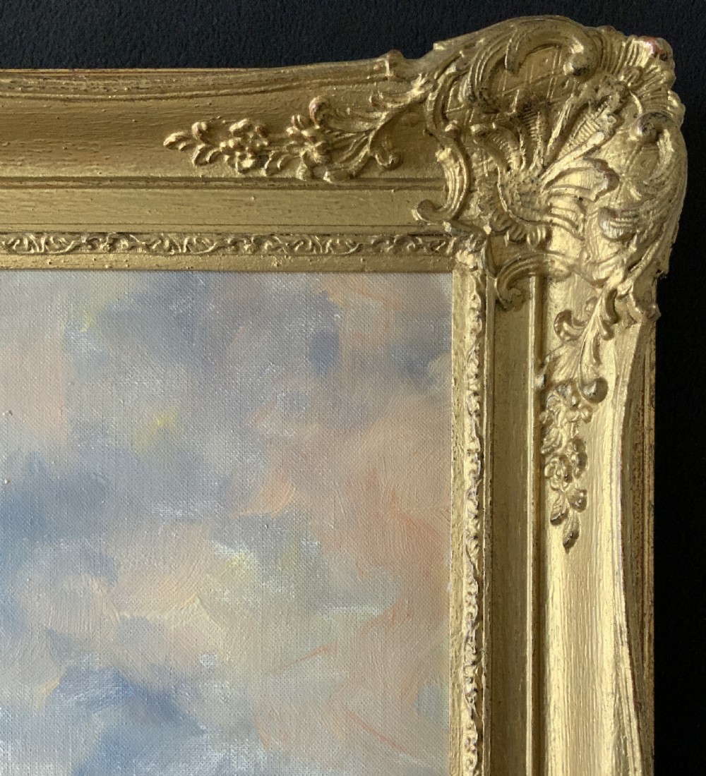 An impressionistic Dutch canalscape oil painting depicting traditional barges alongside a grassy riverbank, housed in an ornate carved gold frame. View XII