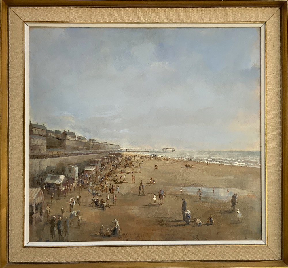 An impressionist oil painting on board depicting a crowded British seaside beach with a pier in the distance, housed in a gilt frame with a fabric liner.