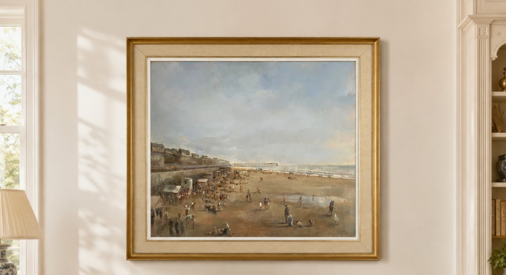 An impressionist oil painting on board depicting a crowded British seaside beach with a pier in the distance, housed in a gilt frame with a fabric liner. View II