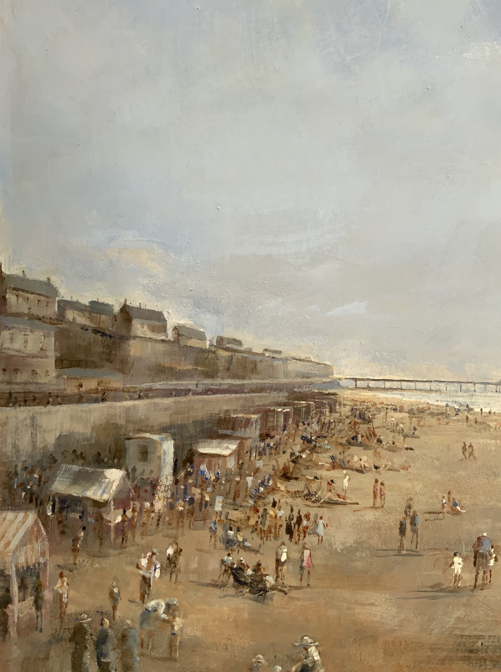 An impressionist oil painting on board depicting a crowded British seaside beach with a pier in the distance, housed in a gilt frame with a fabric liner. View VIII