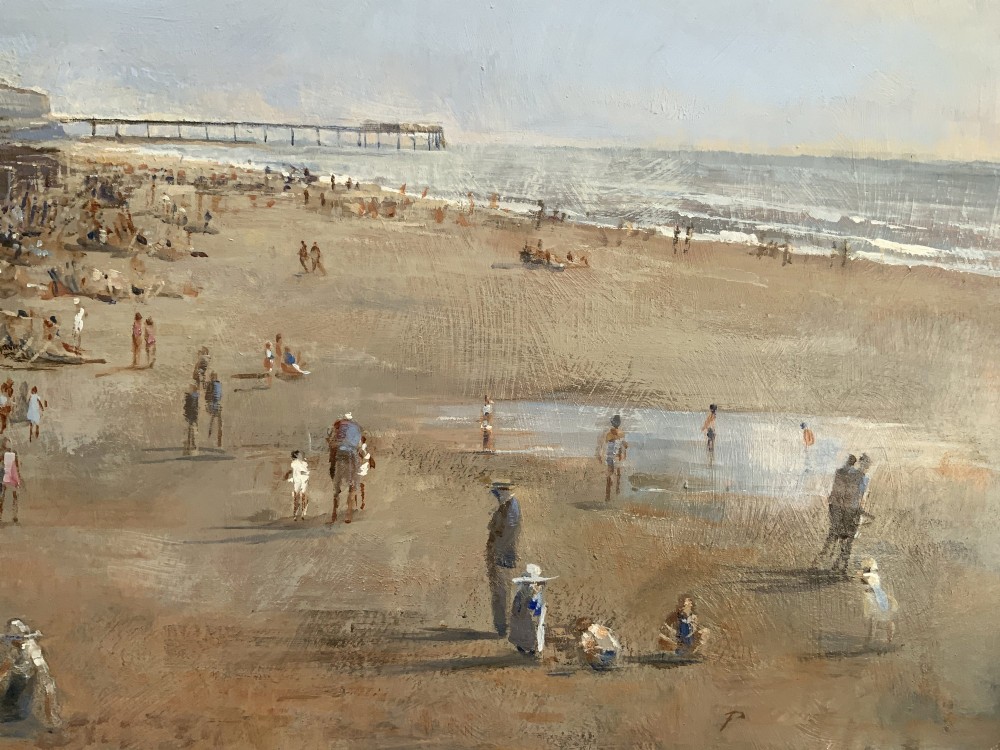 An impressionist oil painting on board depicting a crowded British seaside beach with a pier in the distance, housed in a gilt frame with a fabric liner. View X