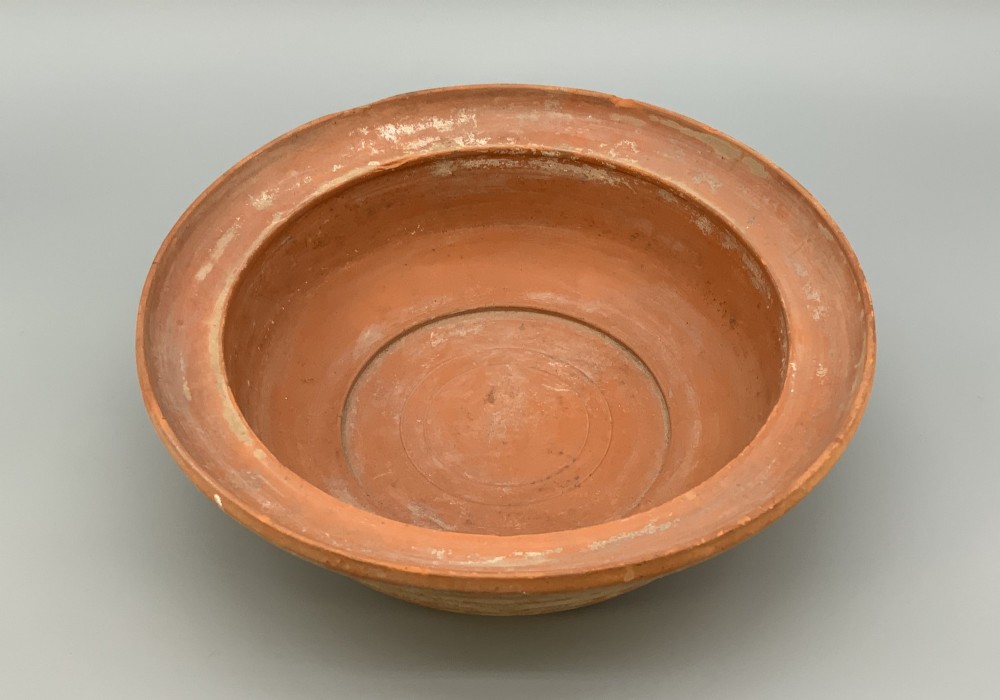 A pair of circular Han Dynasty red terracotta pottery basins featuring broad everted rims and horizontal exterior grooves. View VI
