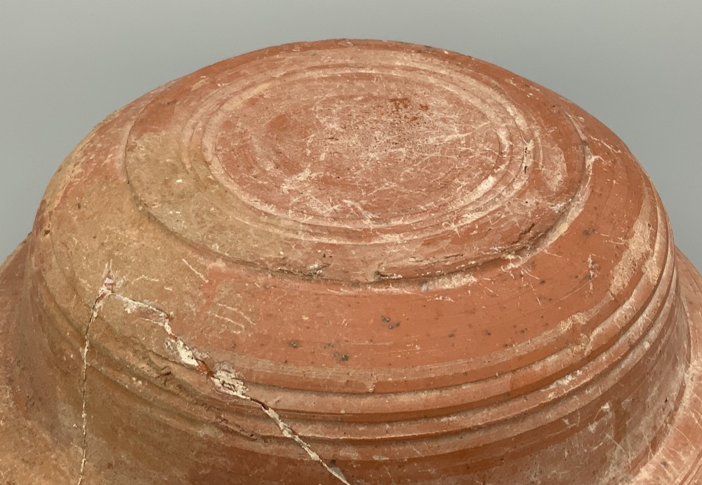 A pair of circular Han Dynasty red terracotta pottery basins featuring broad everted rims and horizontal exterior grooves. View XII