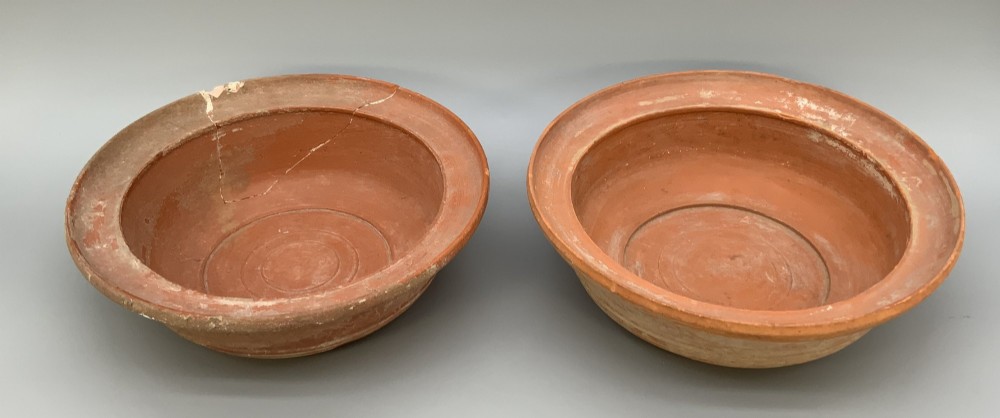 A pair of circular Han Dynasty red terracotta pottery basins featuring broad everted rims and horizontal exterior grooves. View XIV