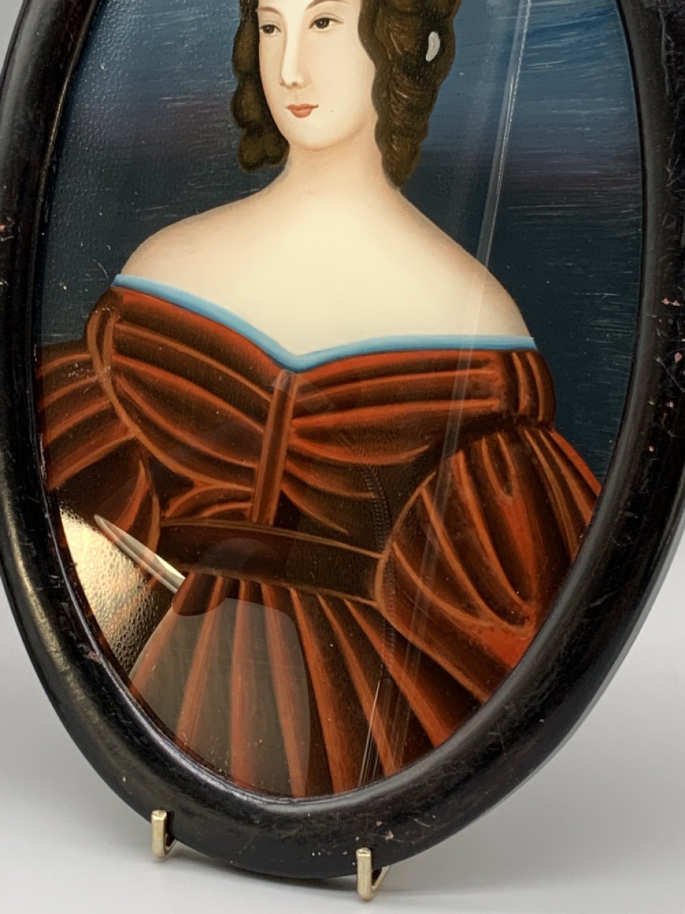 A pair of Japanese Meiji period miniature portrait paintings in oval dark rosewood frames, depicting women in 19th-century style dresses. View VI