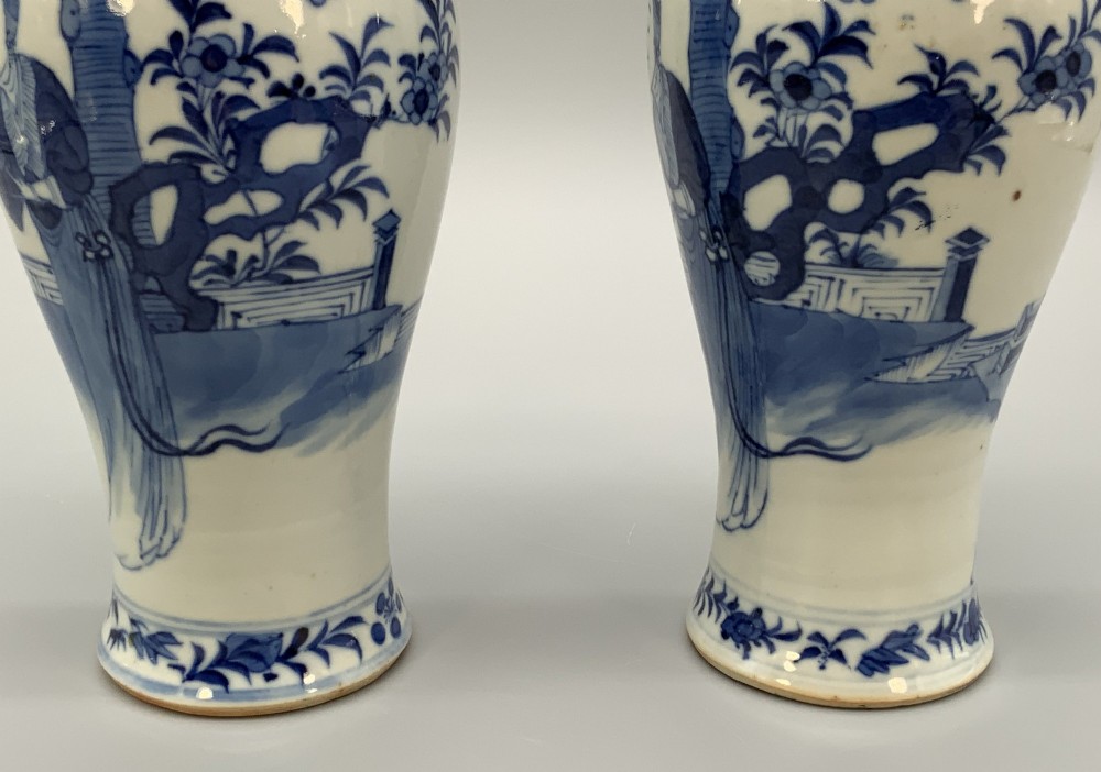 A pair of flared Chinese blue and white porcelain vases hand painted with figural court ladies amidst floral motifs. View VII