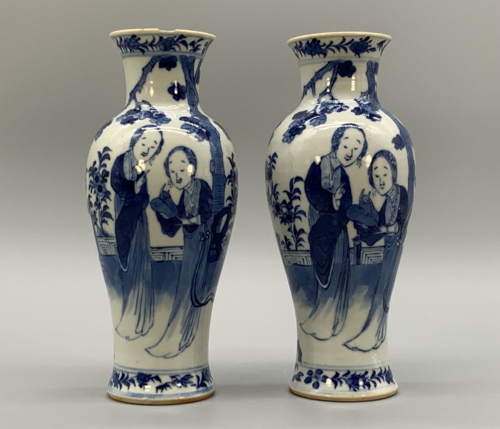 A pair of flared Chinese blue and white porcelain vases hand painted with figural court ladies amidst floral motifs. View VIII