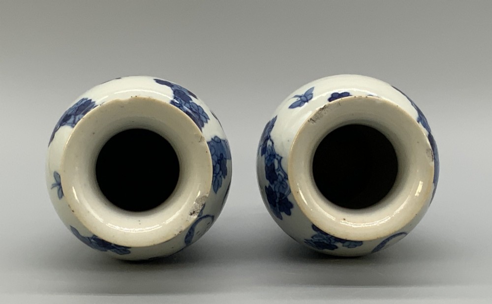 A pair of flared Chinese blue and white porcelain vases hand painted with figural court ladies amidst floral motifs. View IX