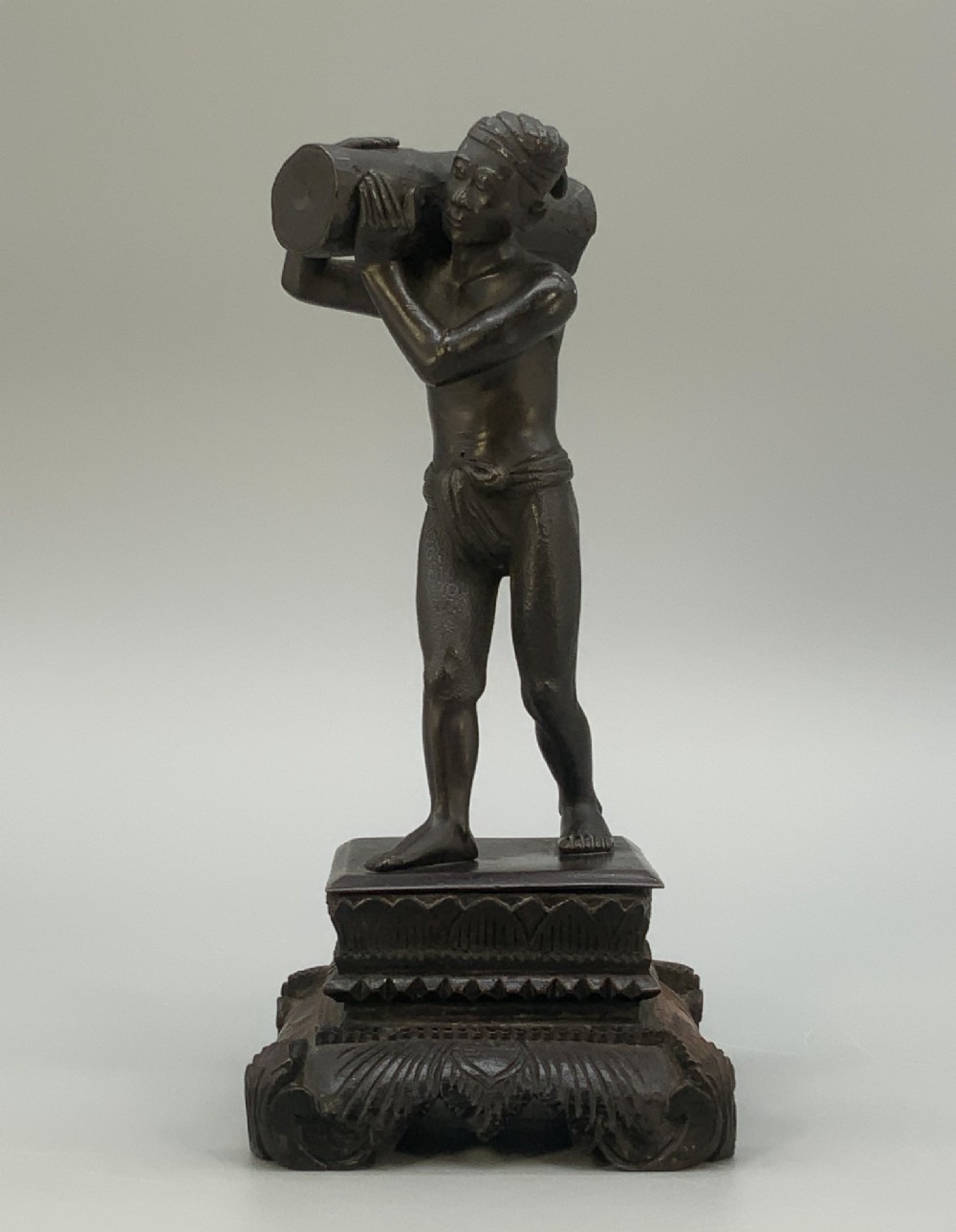 Antique Burmese Pegu Bronze Figurine Sculpture Carrying a Burden on Carved Stand