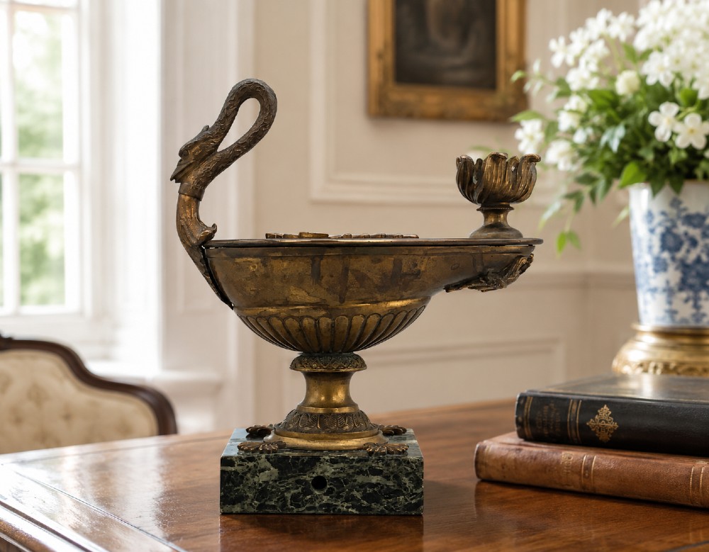 A nineteenth-century Grand Tour patinated bronze oil lamp featuring a serpent handle and gadrooned body, mounted on a square green marble base. View II