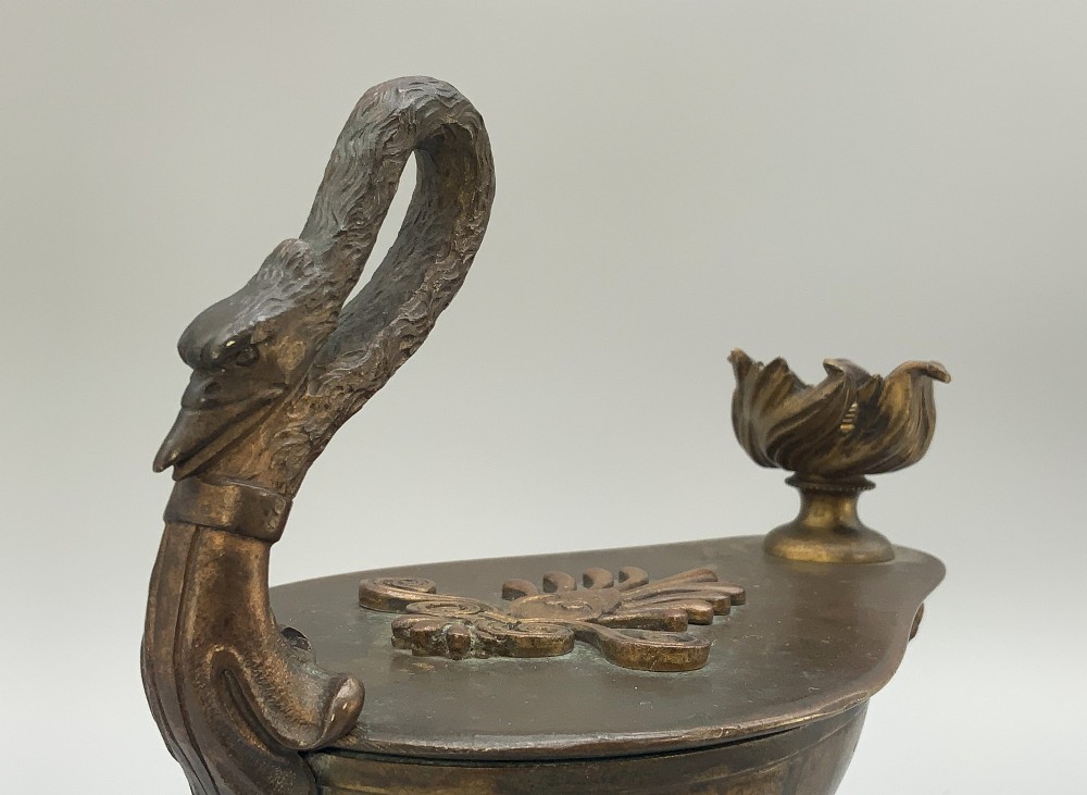 A nineteenth-century Grand Tour patinated bronze oil lamp featuring a serpent handle and gadrooned body, mounted on a square green marble base. View V