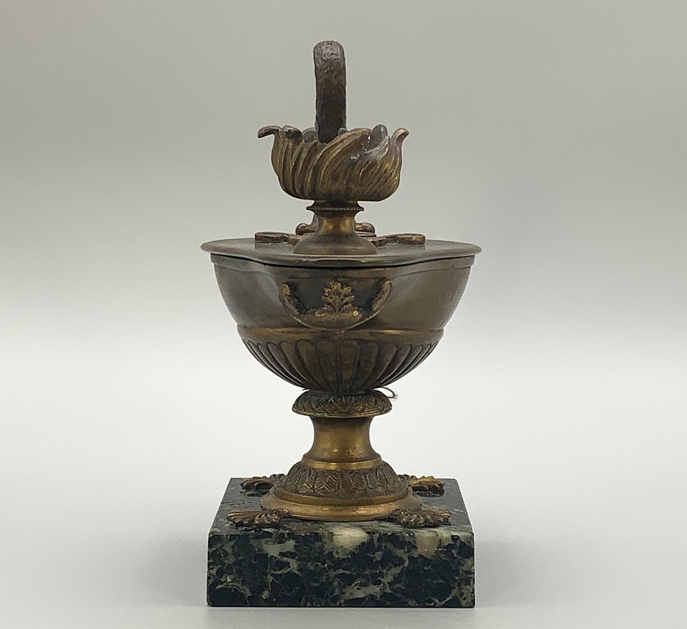 A nineteenth-century Grand Tour patinated bronze oil lamp featuring a serpent handle and gadrooned body, mounted on a square green marble base. View IX