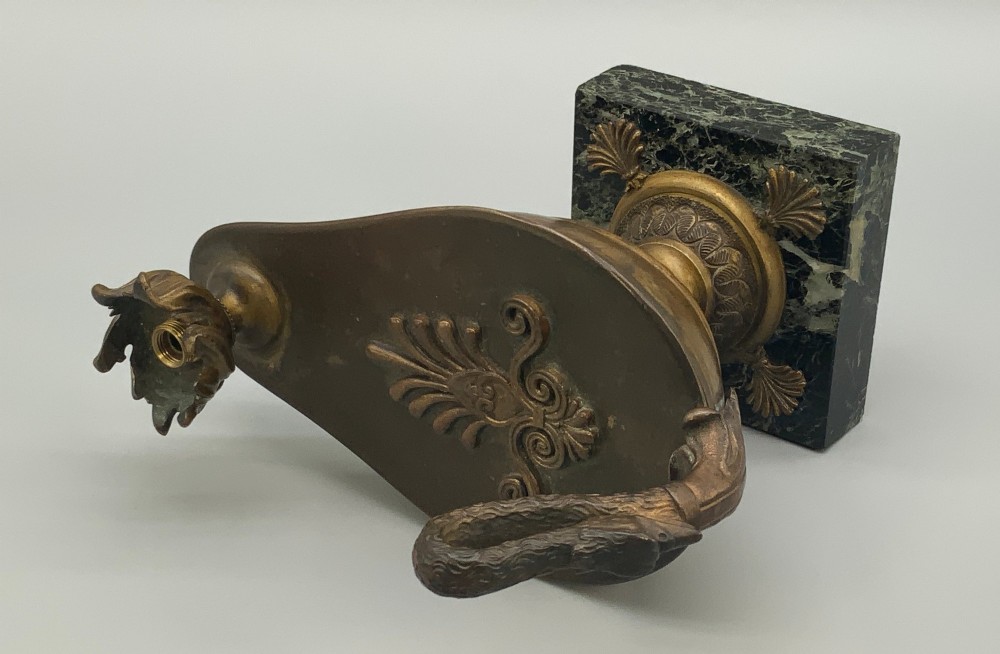 A nineteenth-century Grand Tour patinated bronze oil lamp featuring a serpent handle and gadrooned body, mounted on a square green marble base. View XIII