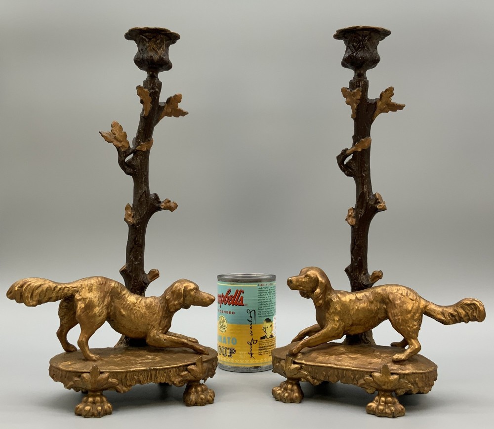 A pair of 19th-century gilded and patinated bronze candlesticks featuring detailed figures of hunting dogs at the base beneath tree-branch shafts. View III