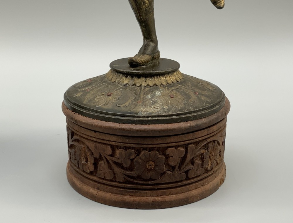 A pair of 19th-century polychrome spelter figural candlesticks depicting male and female torchbearer figures raised on carved wooden bases. View IX