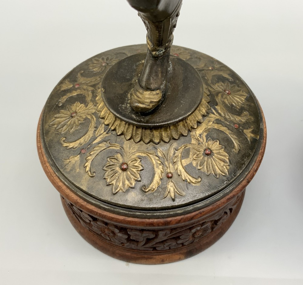 A pair of 19th-century polychrome spelter figural candlesticks depicting male and female torchbearer figures raised on carved wooden bases. View XV
