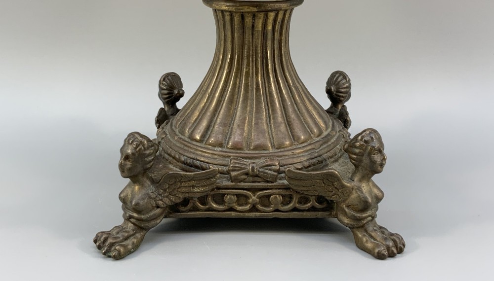 A Renaissance Revival faience vase featuring blue and yellow glazed classical medallion artwork mounted on a cast bronze footed base with mask handles. View IX