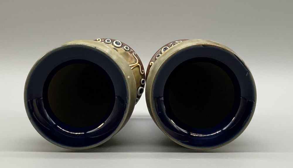 A matched pair of Royal Doulton Lambeth Art Nouveau stoneware vases featuring raised relief botanical motifs on a muted olive green glazed ground. View VIII