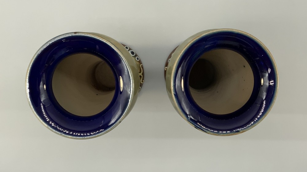 A matched pair of Royal Doulton Lambeth Art Nouveau stoneware vases featuring raised relief botanical motifs on a muted olive green glazed ground. View XI