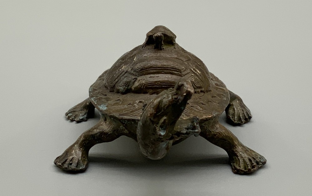 A small Japanese Meiji period bronze sculpture of a minogame turtle with a smaller turtle perched on its shell. View VI