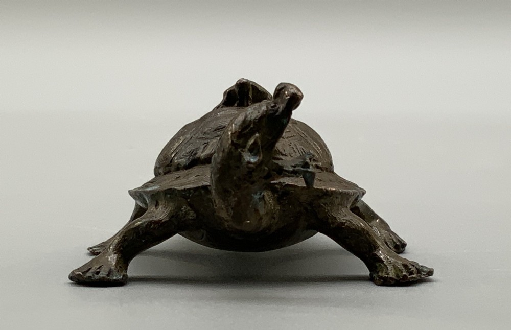 A small Japanese Meiji period bronze sculpture of a minogame turtle with a smaller turtle perched on its shell. View VII