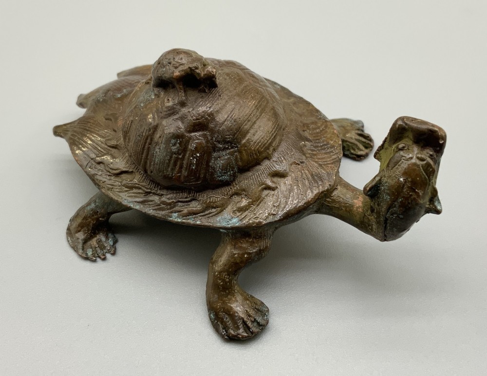 A small Japanese Meiji period bronze sculpture of a minogame turtle with a smaller turtle perched on its shell. View VIII