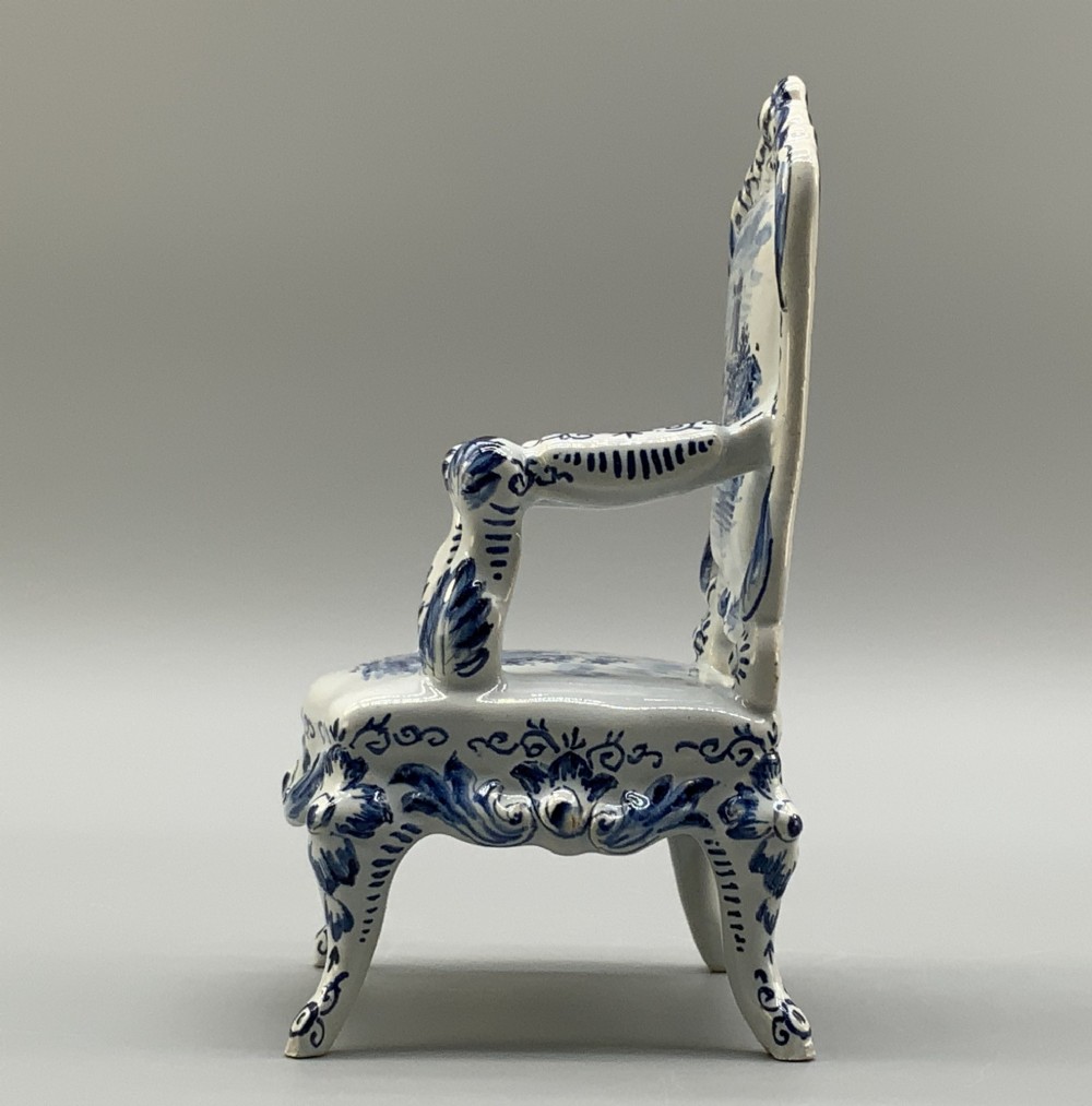 A late 19th-century miniature porcelain armchair glazed in white and hand-painted with blue Dutch landscape scenes featuring a windmill. View VIII