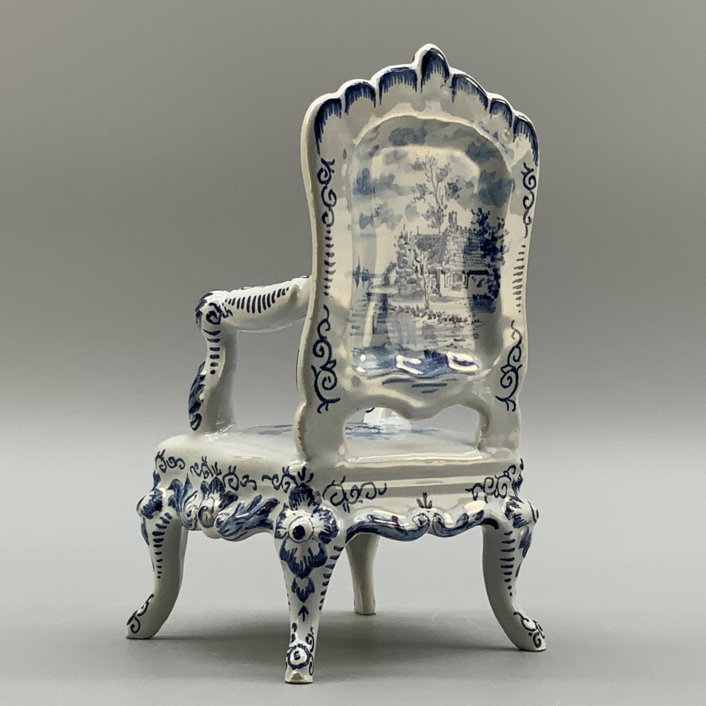 A late 19th-century miniature porcelain armchair glazed in white and hand-painted with blue Dutch landscape scenes featuring a windmill. View IX