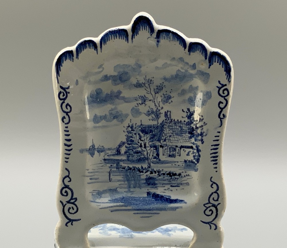A late 19th-century miniature porcelain armchair glazed in white and hand-painted with blue Dutch landscape scenes featuring a windmill. View XI