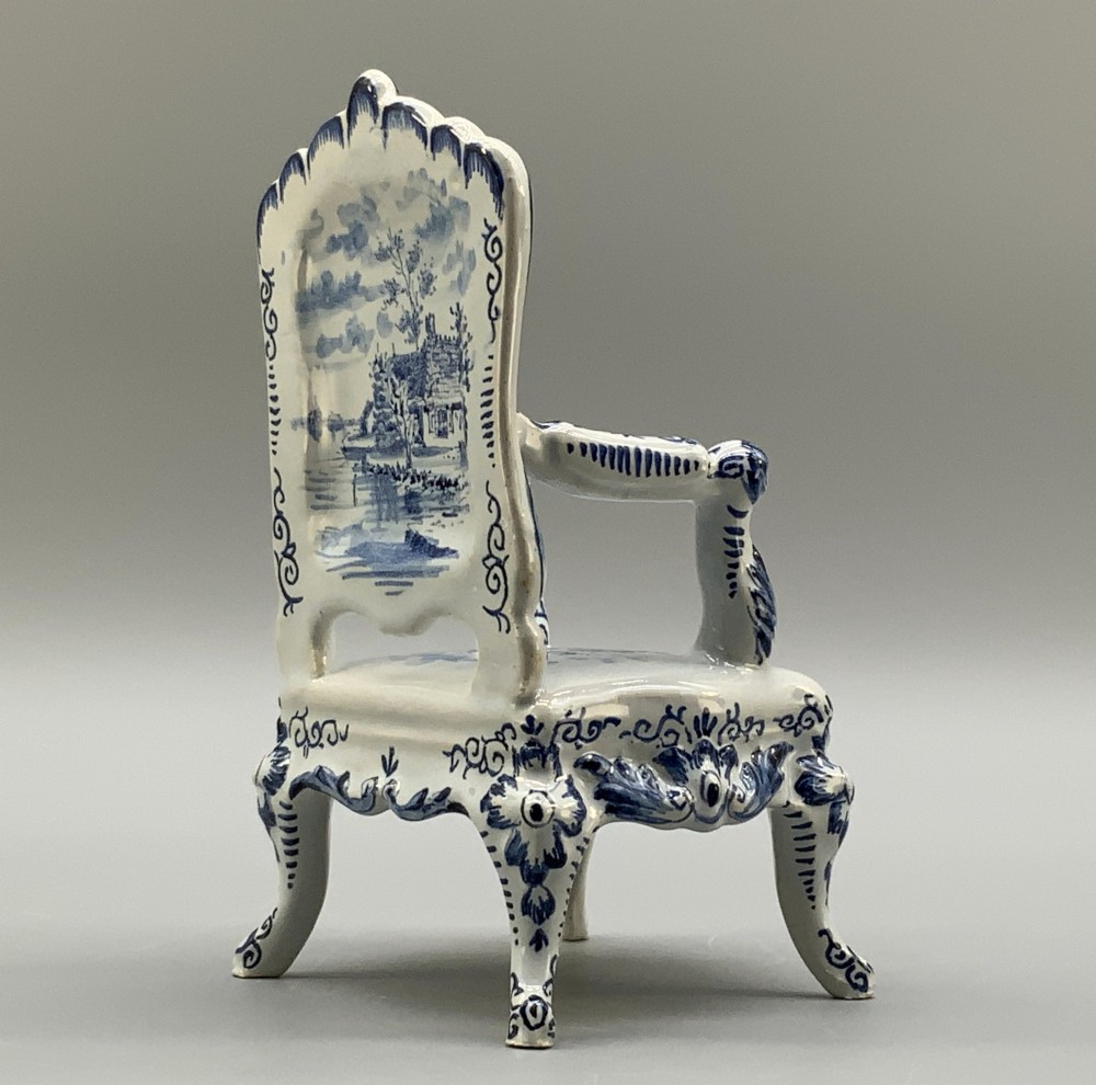 A late 19th-century miniature porcelain armchair glazed in white and hand-painted with blue Dutch landscape scenes featuring a windmill. View XII