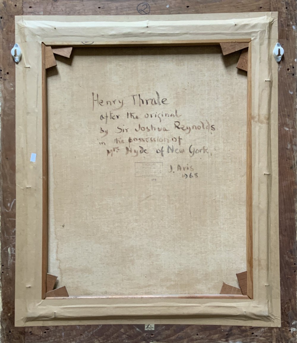 An antique oil painting depicting a half-length portrait of a gentleman in a dark red coat, set within a carved gilded frame with a metal title plaque at the bottom. View XI
