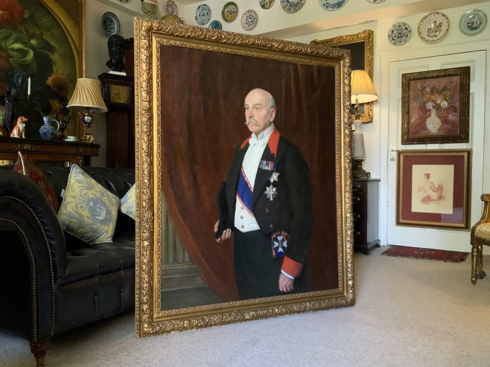 An Edwardian portrait painting of a military officer wearing decorations and set within a carved gold frame. View XI