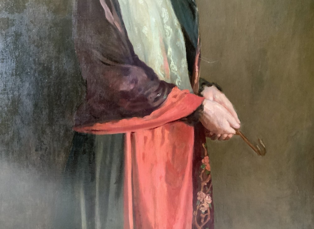 A monumental Edwardian oil portrait on canvas depicting a seated woman in classical attire, framed in an ornate carved gold giltwood frame. View VII
