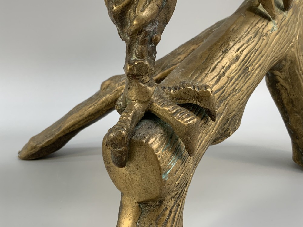 A cast brass sculpture depicting an eagle with outstretched wings perched atop a detailed log branch. View XV