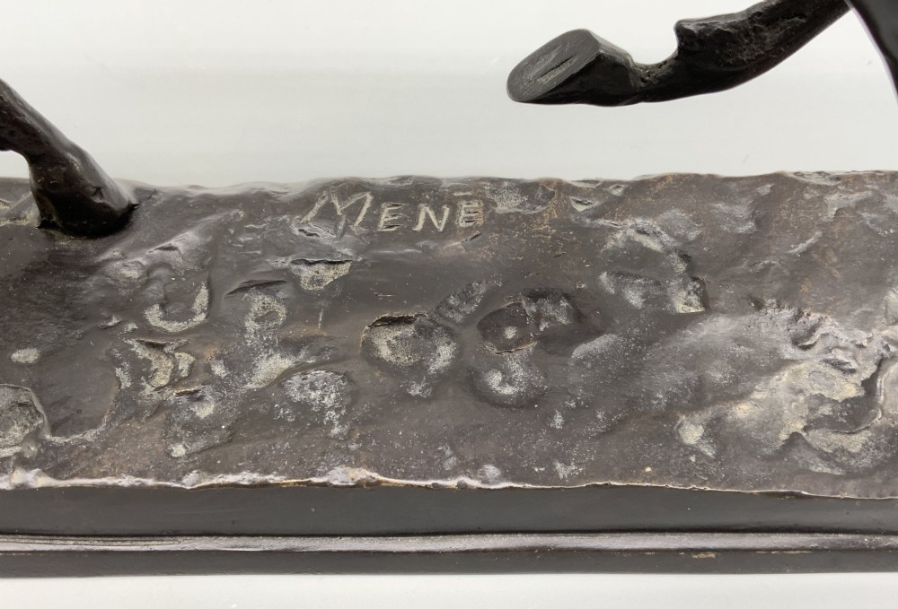 A patinated bronze sculpture depicting a racehorse and jockey mid-stride set upon a textured rectangular bronze base. View XII