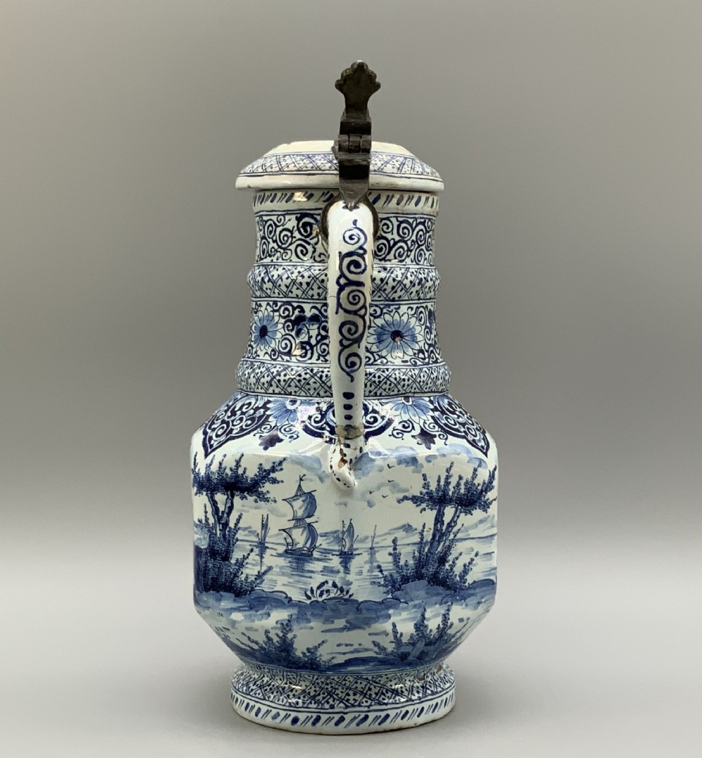 An eighteenth-century blue and white Dutch Delftware ceramic jug decorated with hand-painted figures, complete with a fitted pewter lid. View IV