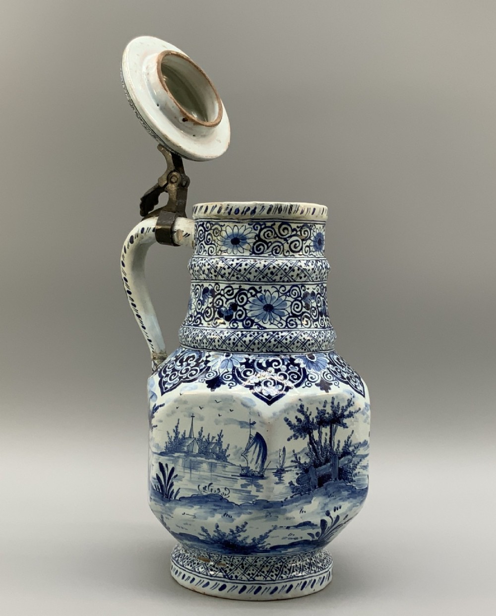 An eighteenth-century blue and white Dutch Delftware ceramic jug decorated with hand-painted figures, complete with a fitted pewter lid. View VII