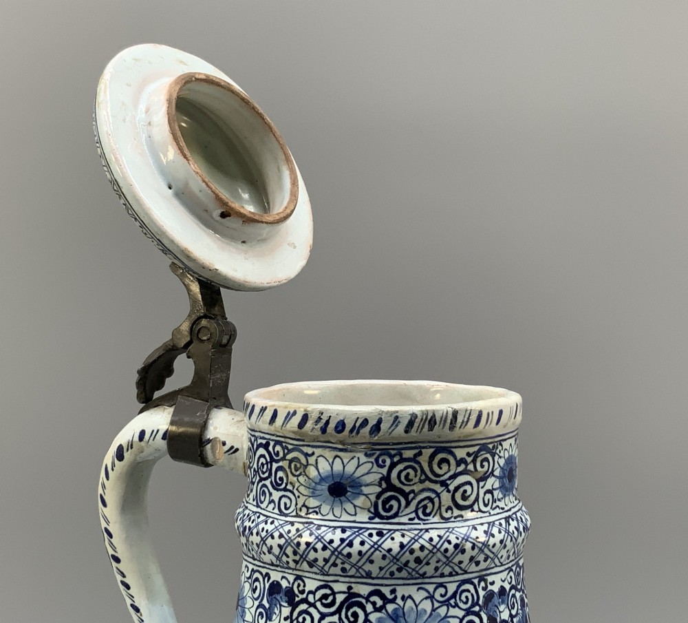 An eighteenth-century blue and white Dutch Delftware ceramic jug decorated with hand-painted figures, complete with a fitted pewter lid. View VIII