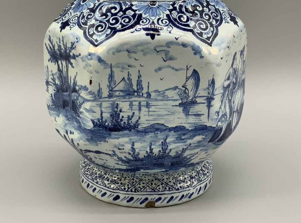 An eighteenth-century blue and white Dutch Delftware ceramic jug decorated with hand-painted figures, complete with a fitted pewter lid. View XI