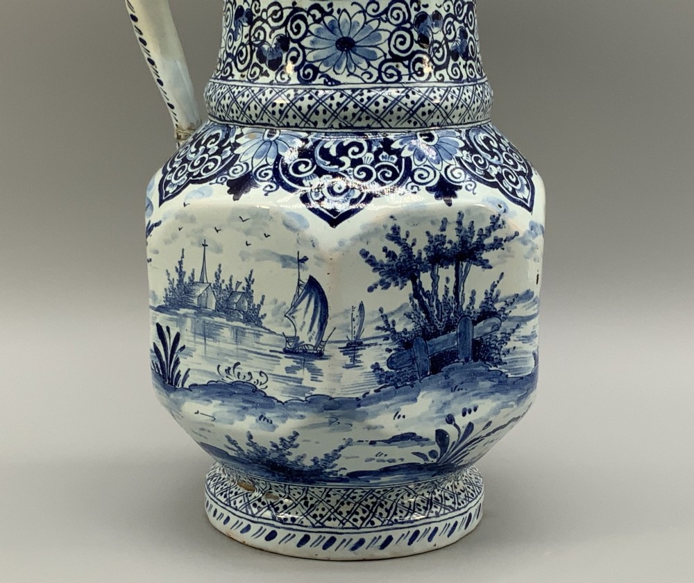 An eighteenth-century blue and white Dutch Delftware ceramic jug decorated with hand-painted figures, complete with a fitted pewter lid. View XII