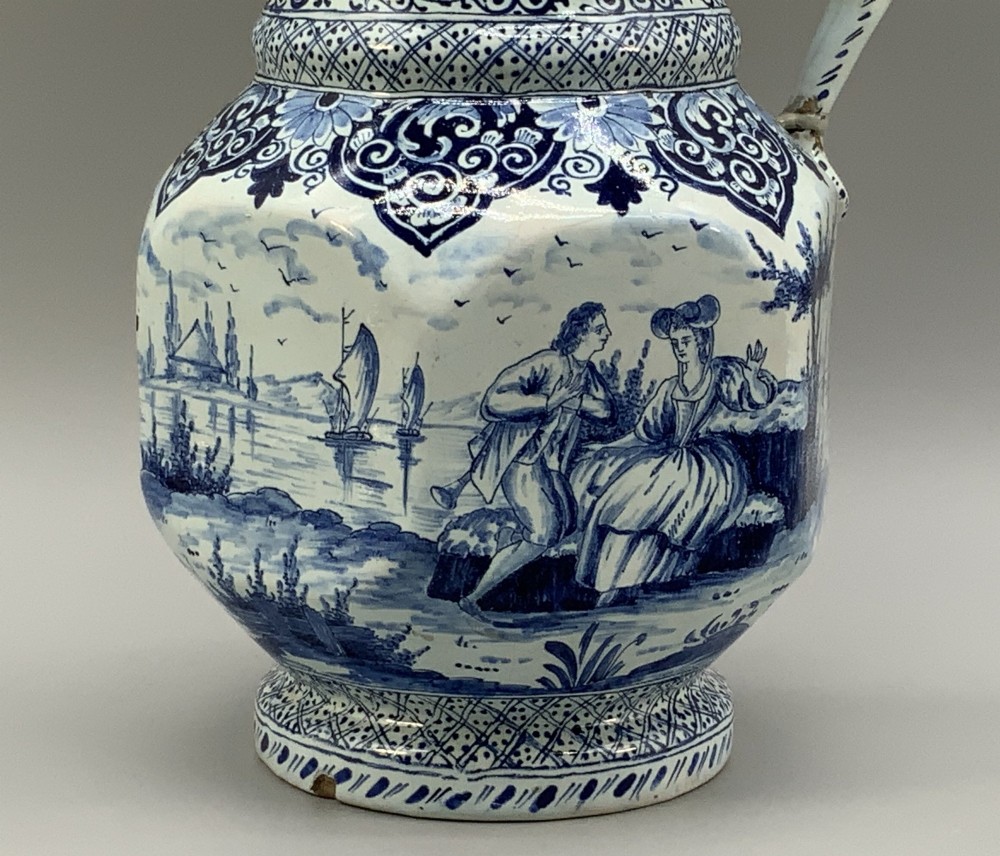 An eighteenth-century blue and white Dutch Delftware ceramic jug decorated with hand-painted figures, complete with a fitted pewter lid. View XIII