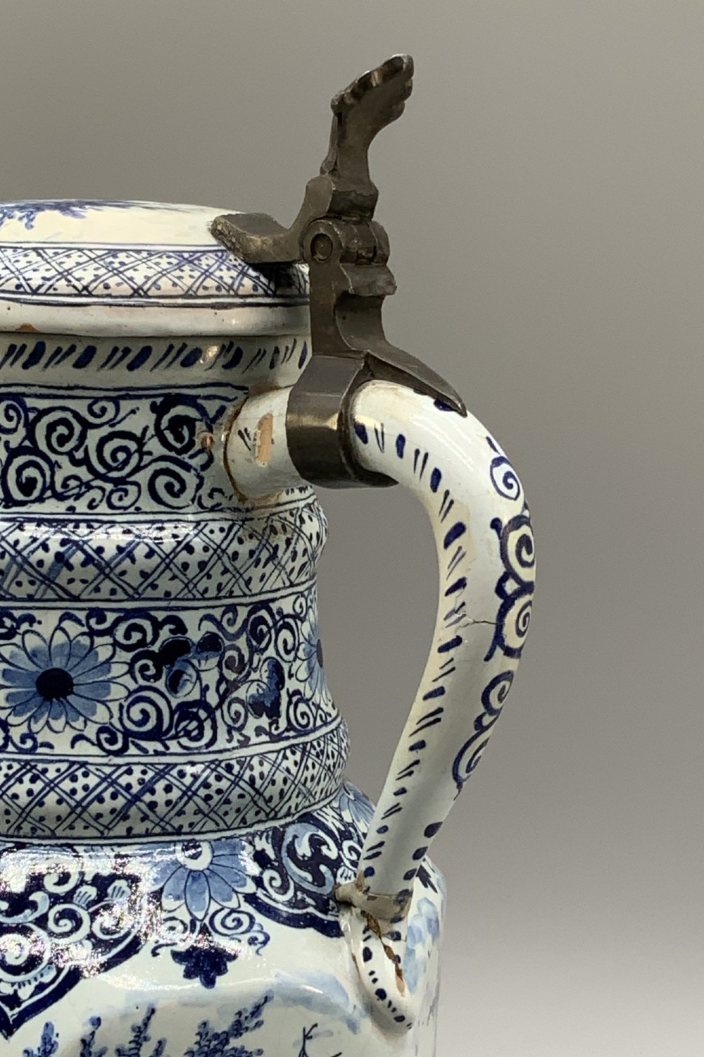 An eighteenth-century blue and white Dutch Delftware ceramic jug decorated with hand-painted figures, complete with a fitted pewter lid. View XIV
